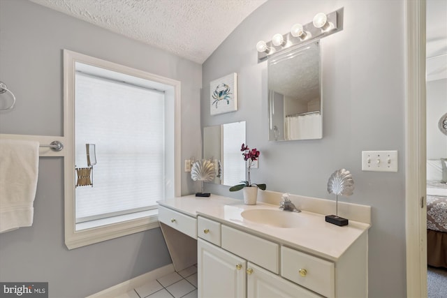 full bath featuring vanity, a textured ceiling, ensuite bath, and tile patterned flooring