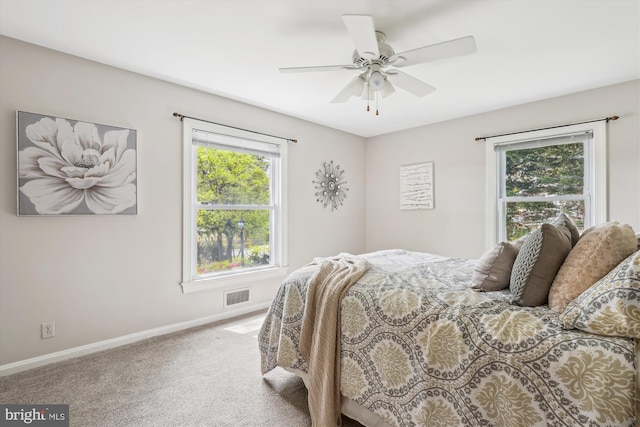 bedroom with carpet floors, a ceiling fan, baseboards, and visible vents