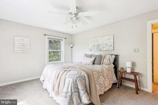 bedroom with baseboards, ceiling fan, and light carpet