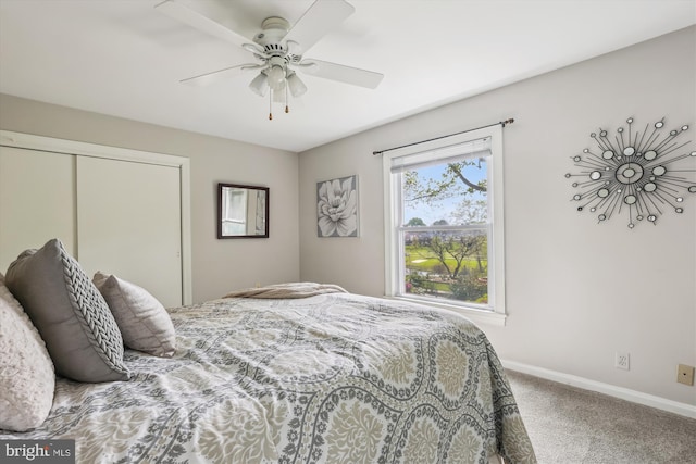 bedroom featuring a closet, baseboards, ceiling fan, and carpet flooring