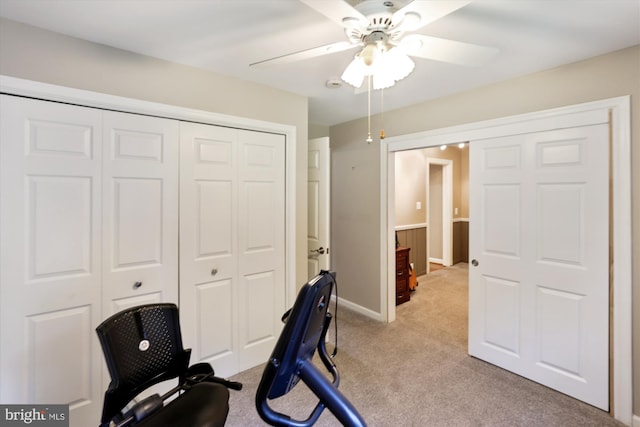 office space with baseboards, ceiling fan, and light colored carpet
