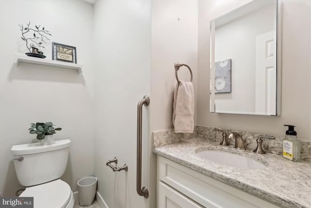 half bathroom featuring toilet and vanity