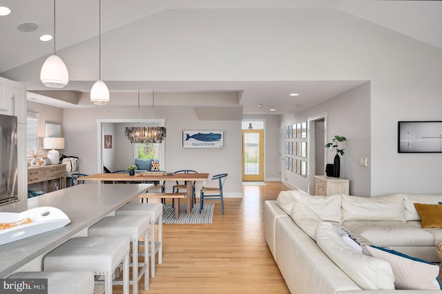 living area featuring vaulted ceiling, light wood-type flooring, a chandelier, baseboards, and recessed lighting
