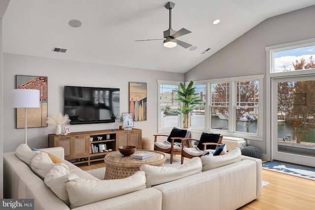 living room featuring wood finished floors, ceiling fan, lofted ceiling, healthy amount of natural light, and recessed lighting