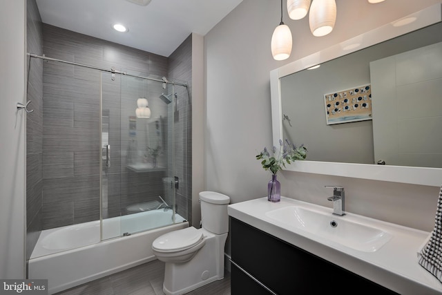 full bathroom with toilet, vanity, enclosed tub / shower combo, recessed lighting, and wood finished floors