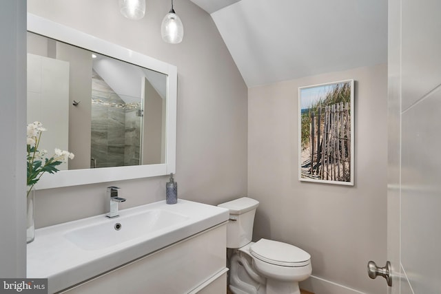 full bathroom with lofted ceiling, toilet, a tile shower, and vanity