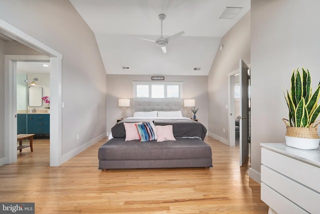 bedroom with lofted ceiling, light wood finished floors, and baseboards