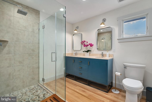 bathroom featuring a shower stall, wood finished floors, and recessed lighting