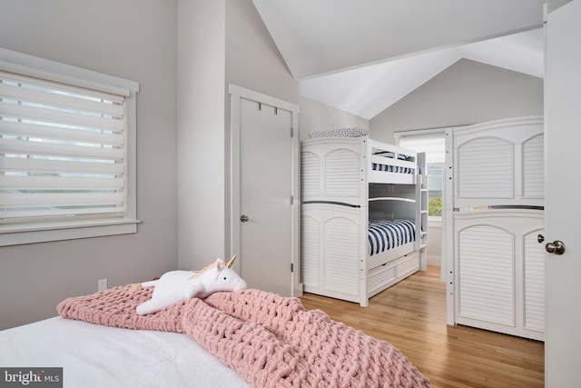 bedroom featuring vaulted ceiling and wood finished floors