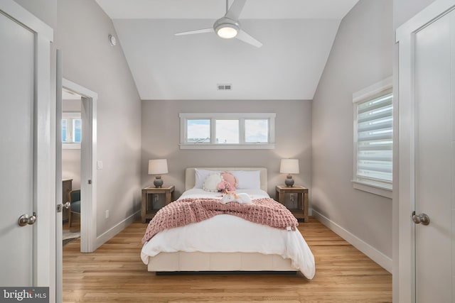 bedroom with lofted ceiling, light wood-style floors, baseboards, and a ceiling fan