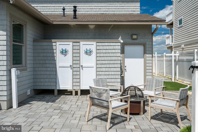 view of patio / terrace with an outdoor fire pit and fence