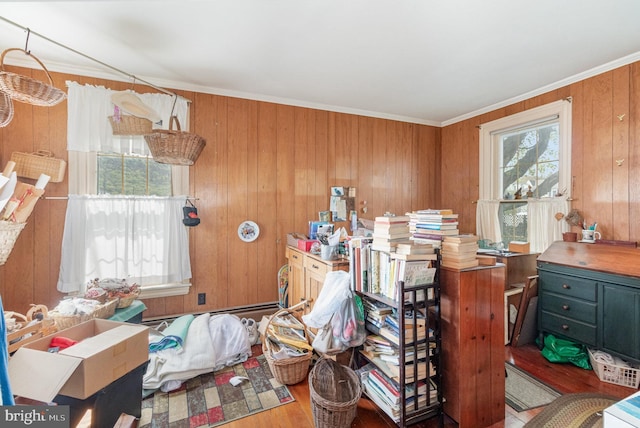 misc room with wood finished floors, wooden walls, and ornamental molding