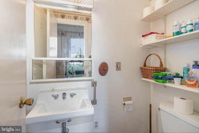 half bathroom featuring toilet and a sink