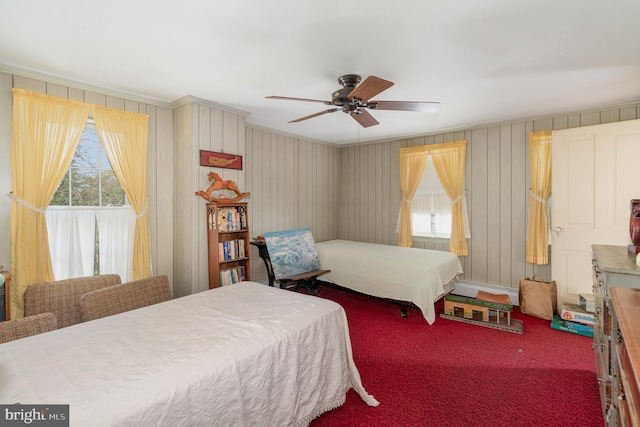 carpeted bedroom with a ceiling fan and crown molding