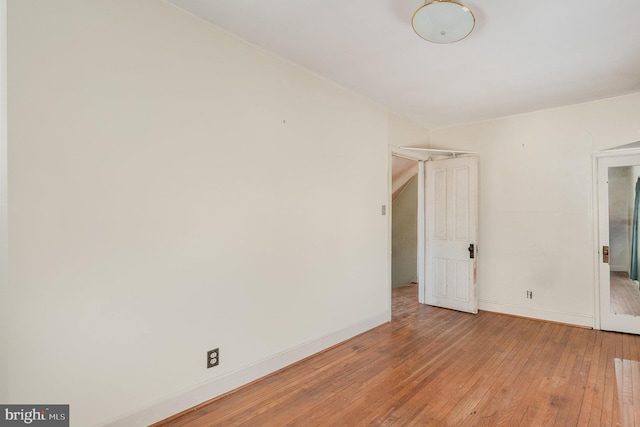 spare room featuring light wood-style flooring and baseboards