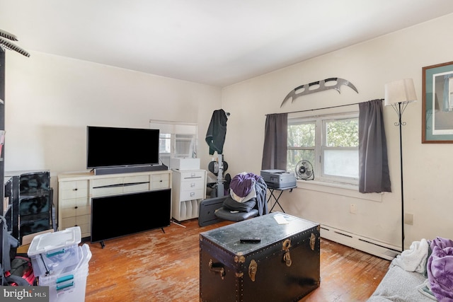 living room with wood finished floors and a baseboard radiator