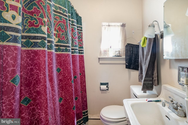 full bath with toilet and a sink