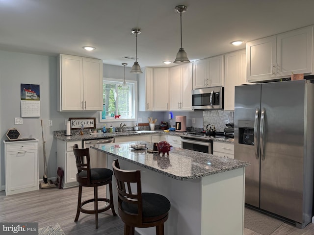 14273 Brandy Ln, Georgetown, DE 19947 - kitchen with stainless steel appliances, stone countertops, white cabinetry, a center island, and recessed lighting