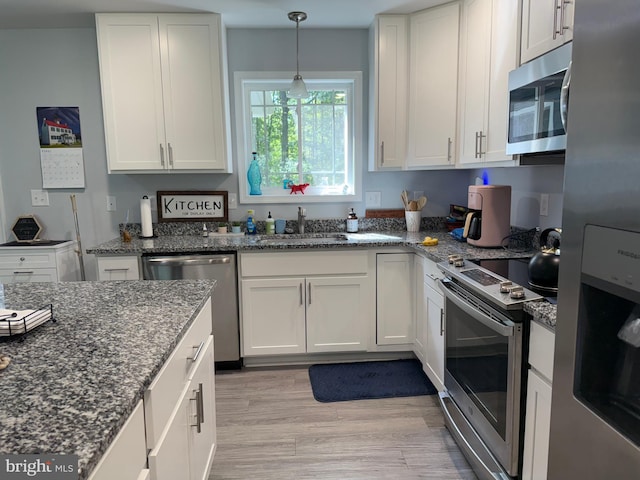 14273 Brandy Ln, Georgetown, DE 19947 - kitchen with appliances with stainless steel finishes, light wood-style flooring, a sink, and white cabinets