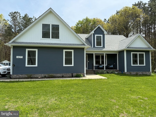 14273 Brandy Ln, Georgetown, DE 19947 - view of front facade with a porch, a front yard, and roof with shingles