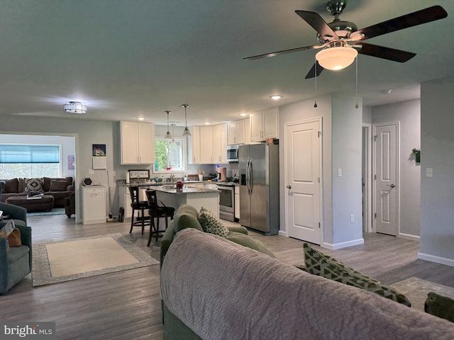 14273 Brandy Ln, Georgetown, DE 19947 - living area with wood finished floors, baseboards, a ceiling fan, and recessed lighting
