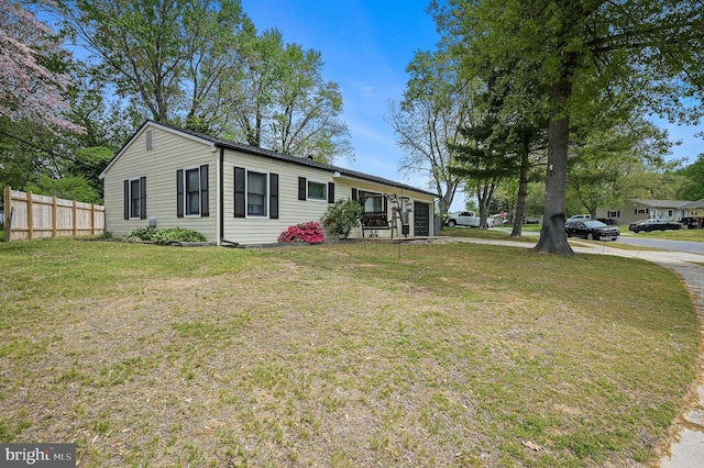 view of front of home with fence and a front yard