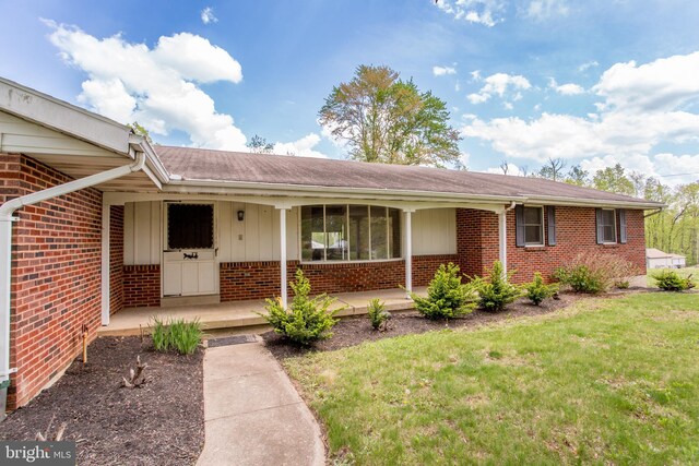 2500 Eberhart Rd, Quakertown, PA 18951 - view of front of property with covered porch, brick siding, and a front yard