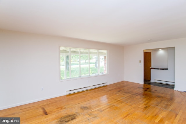 2500 Eberhart Rd, Quakertown, PA 18951 - empty room with wood finished floors, baseboards, a baseboard heating unit, and baseboard heating