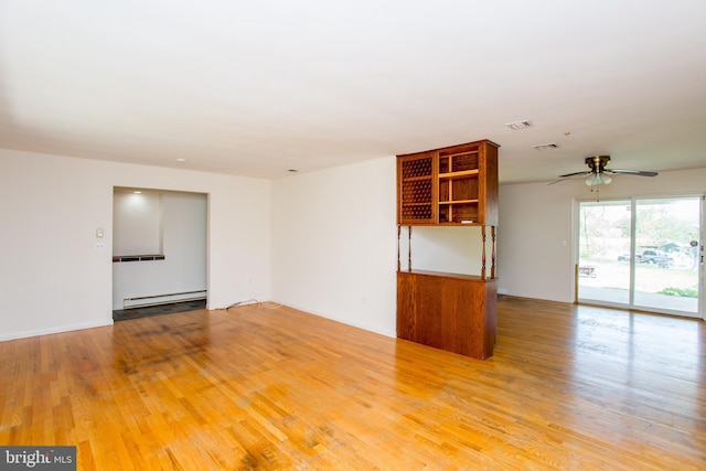 2500 Eberhart Rd, Quakertown, PA 18951 - empty room with visible vents, light wood finished floors, ceiling fan, and baseboard heating