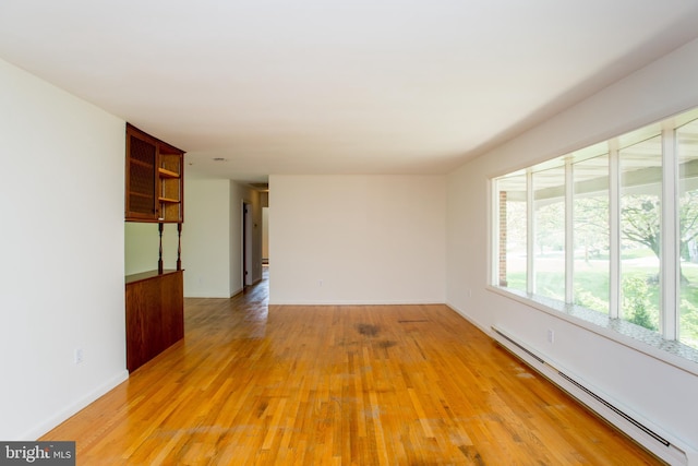 2500 Eberhart Rd, Quakertown, PA 18951 - unfurnished living room with baseboards, light wood finished floors, and a baseboard heating unit
