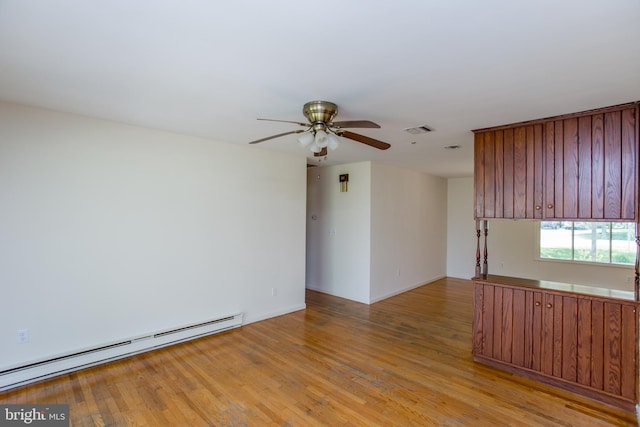 2500 Eberhart Rd, Quakertown, PA 18951 - unfurnished room with ceiling fan, visible vents, baseboards, a baseboard heating unit, and light wood-style flooring