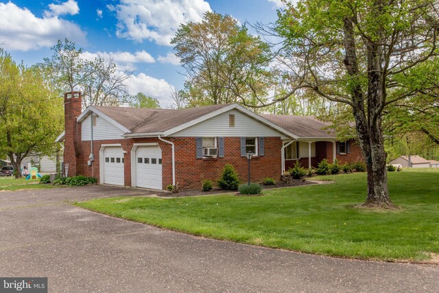 2500 Eberhart Rd, Quakertown, PA 18951 - ranch-style home featuring brick siding, an attached garage, a front lawn, and aphalt driveway