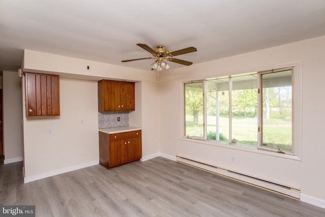 2500 Eberhart Rd, Quakertown, PA 18951 - interior space featuring brown cabinets, a ceiling fan, light wood-style flooring, and a baseboard radiator
