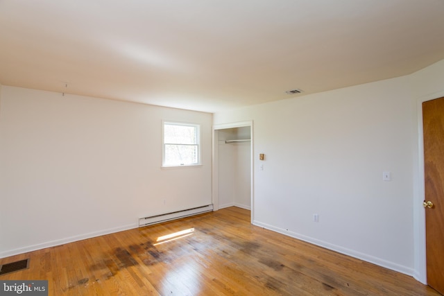 2500 Eberhart Rd, Quakertown, PA 18951 - empty room featuring visible vents, baseboards, wood finished floors, and baseboard heating
