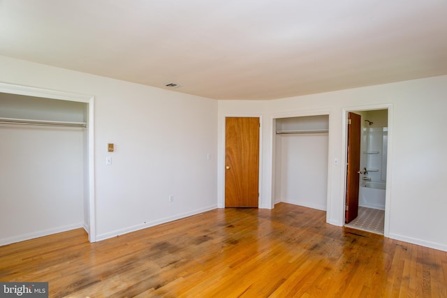 2500 Eberhart Rd, Quakertown, PA 18951 - unfurnished bedroom with visible vents, baseboards, two closets, light wood-style floors, and ensuite bath