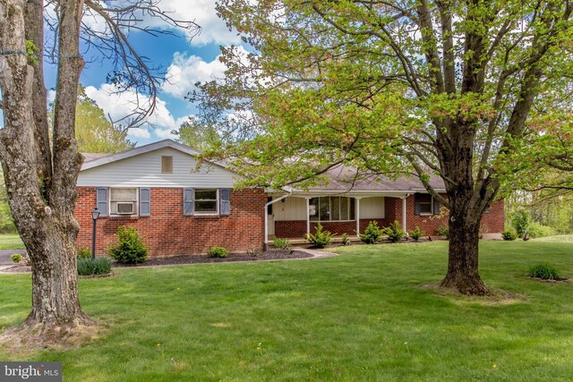 2500 Eberhart Rd, Quakertown, PA 18951 - ranch-style house with covered porch, brick siding, cooling unit, and a front lawn