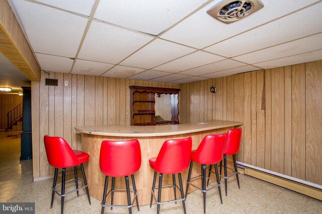 2500 Eberhart Rd, Quakertown, PA 18951 - bar with a drop ceiling, wooden walls, a baseboard heating unit, tile patterned floors, and a bar