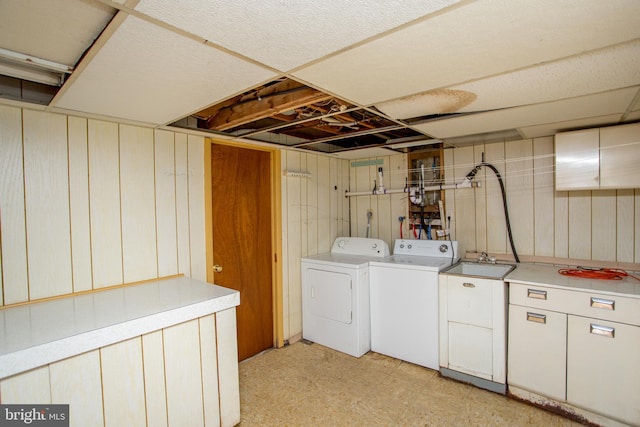 2500 Eberhart Rd, Quakertown, PA 18951 - washroom with a sink, cabinet space, wooden walls, and washing machine and clothes dryer