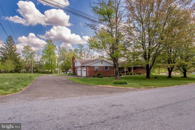 2500 Eberhart Rd, Quakertown, PA 18951 - exterior space featuring a chimney, a lawn, a garage, brick siding, and aphalt driveway