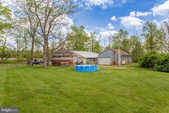 2500 Eberhart Rd, Quakertown, PA 18951 - view of yard featuring a pole building, an outdoor pool, an outbuilding, and a detached garage