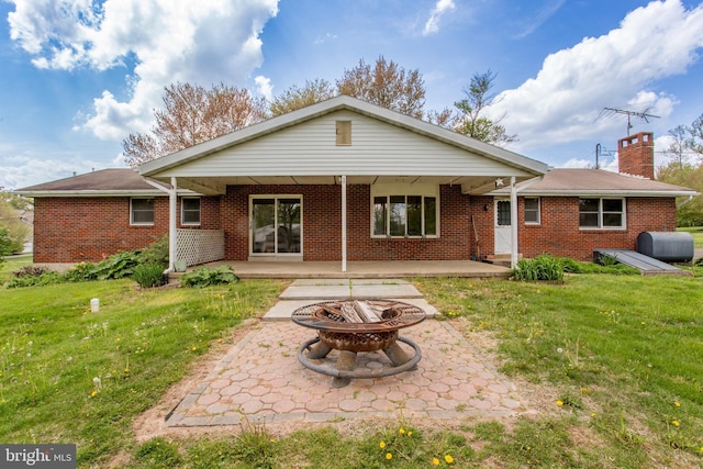2500 Eberhart Rd, Quakertown, PA 18951 - back of property featuring a lawn, an outdoor fire pit, and a patio