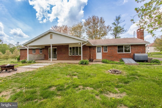 2500 Eberhart Rd, Quakertown, PA 18951 - view of front facade with brick siding, a front yard, and an outdoor fire pit