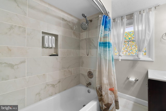 bathroom featuring vanity, shower / tub combo with curtain, and baseboards