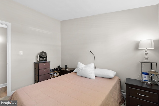 bedroom with baseboards and wood finished floors