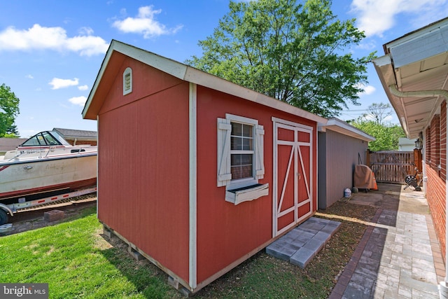 view of shed featuring fence