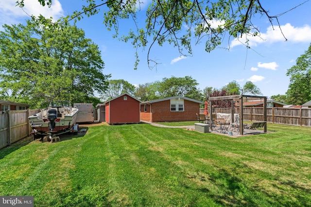 view of yard with a patio, a fenced backyard, a pergola, and an outdoor structure