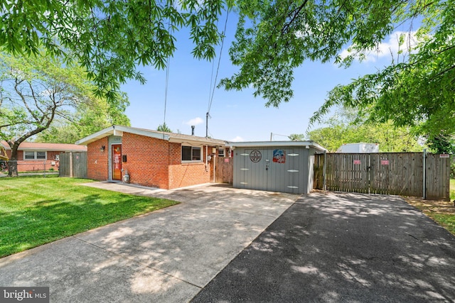 single story home featuring fence, concrete driveway, a front yard, and brick siding
