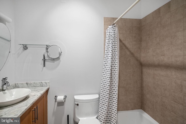 bathroom with vanity, shower / bathtub combination with curtain, and toilet