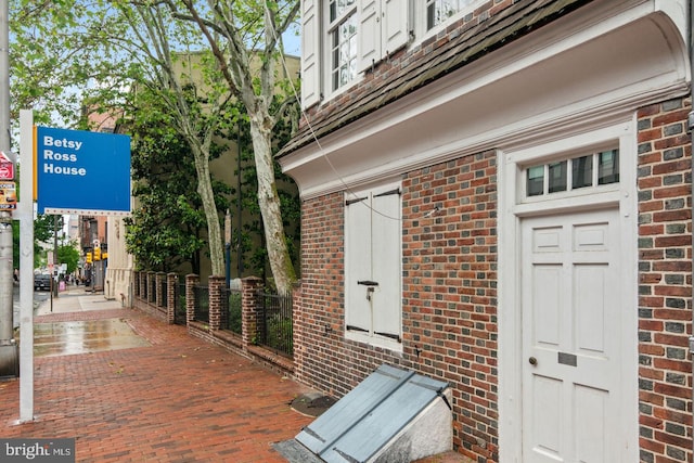 property entrance featuring brick siding