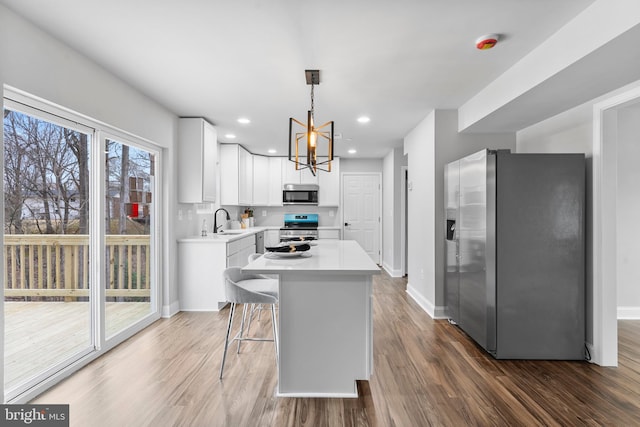 6955 Solomons Island Rd N, Sunderland, MD 20689 - kitchen with light countertops, appliances with stainless steel finishes, dark wood-type flooring, and a sink
